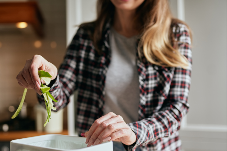 woman using countertop compost bin for apartment composting