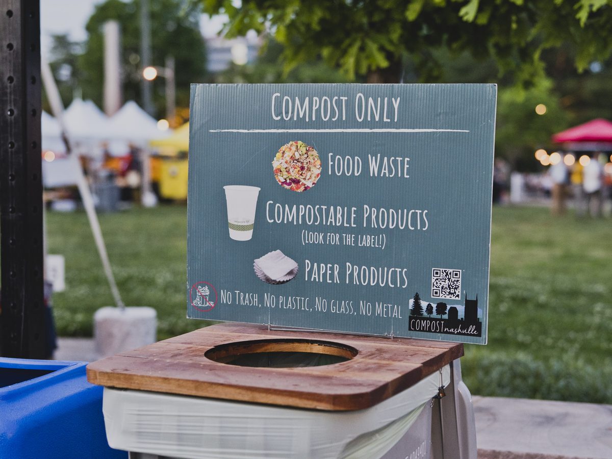 A Compost Nashville compost-only bin and sign set up at an outdoor event
